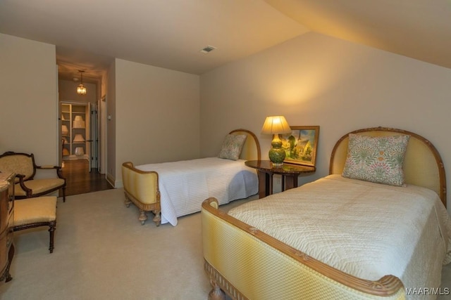 carpeted bedroom with lofted ceiling