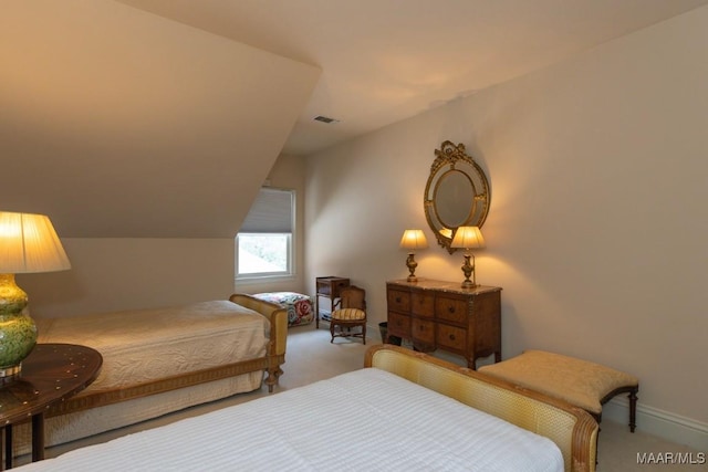 carpeted bedroom featuring lofted ceiling