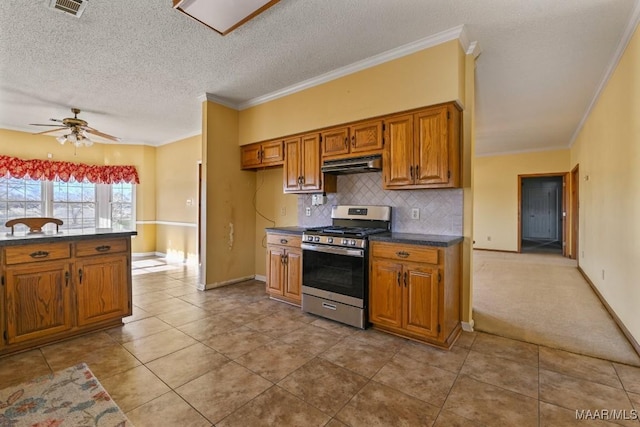 kitchen featuring a textured ceiling, ceiling fan, crown molding, and stainless steel gas range