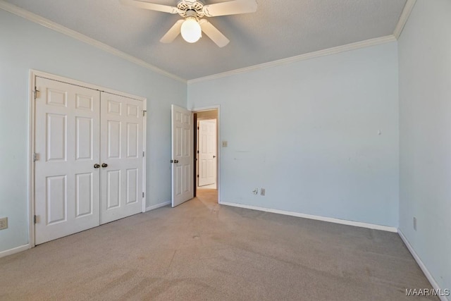 unfurnished bedroom with a closet, light carpet, ceiling fan, and ornamental molding