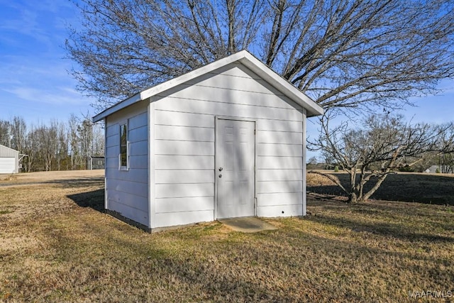 view of outbuilding featuring a yard