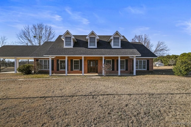 cape cod home with a porch and a front lawn