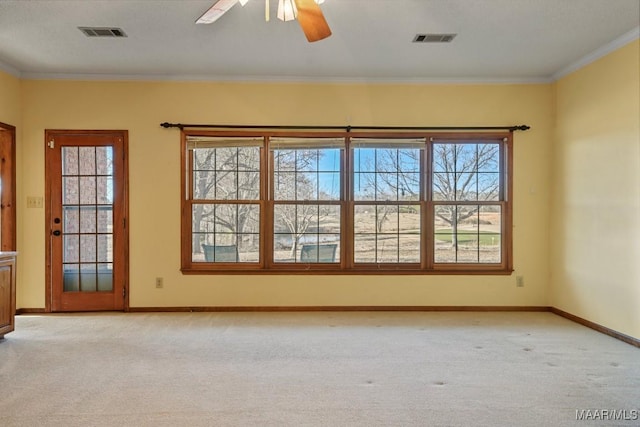 unfurnished room featuring ornamental molding, ceiling fan, and light carpet