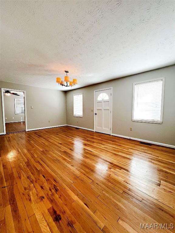 foyer with light wood-type flooring and a healthy amount of sunlight