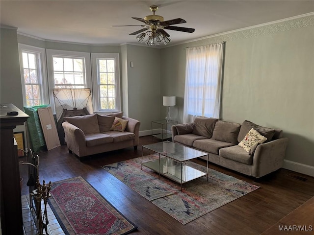 living room featuring ceiling fan, crown molding, and dark wood-type flooring