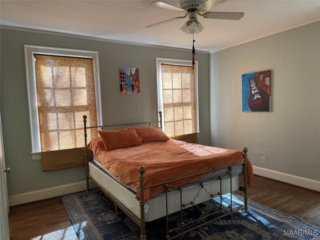 bedroom featuring dark wood-type flooring, ceiling fan, and ornamental molding