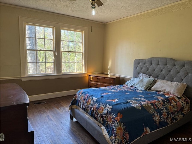 bedroom with multiple windows, a textured ceiling, dark wood-type flooring, and ceiling fan