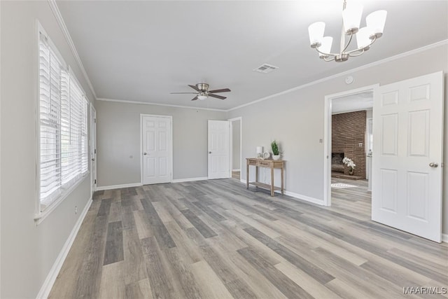 interior space featuring light wood-type flooring, visible vents, and crown molding