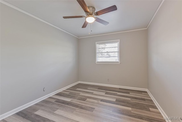 spare room featuring light wood-style floors, ceiling fan, baseboards, and crown molding