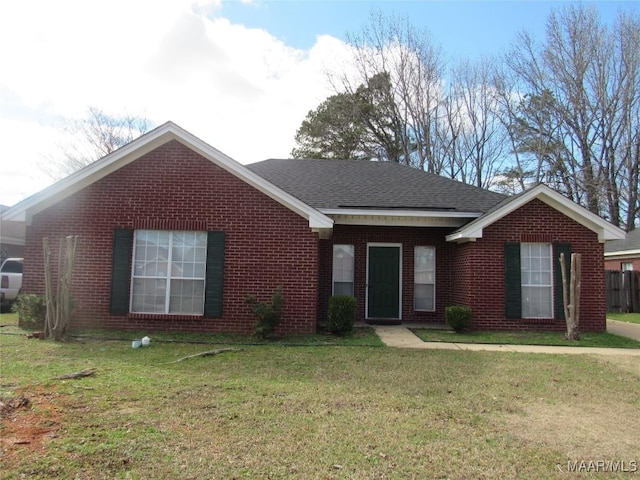 ranch-style house with a front lawn, brick siding, and roof with shingles