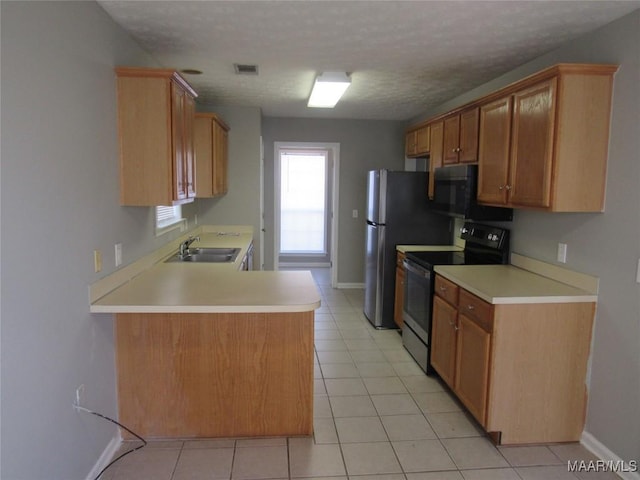 kitchen with visible vents, a sink, light countertops, electric stove, and black microwave