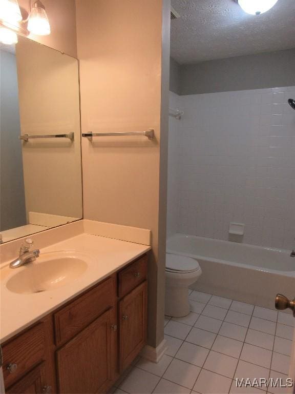 full bathroom featuring toilet, shower / bathing tub combination, tile patterned floors, a textured ceiling, and vanity