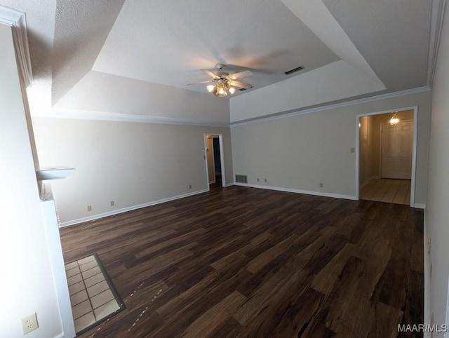 unfurnished room featuring ceiling fan, dark hardwood / wood-style flooring, and a raised ceiling