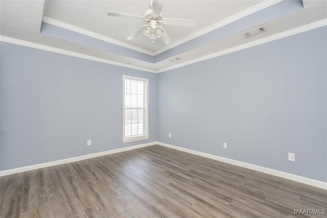 unfurnished room with hardwood / wood-style flooring, a raised ceiling, ceiling fan, and crown molding