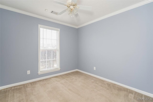 carpeted empty room featuring ceiling fan and crown molding