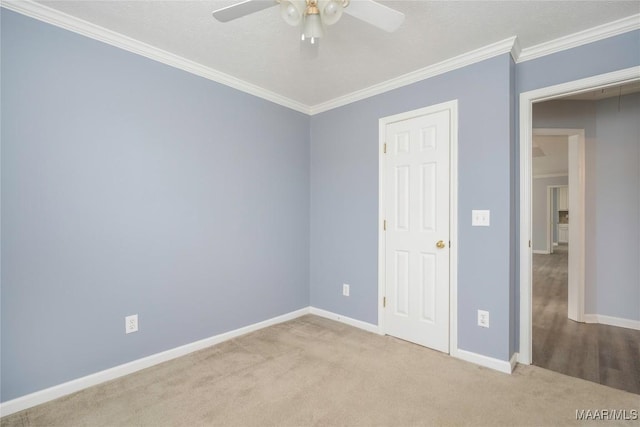 unfurnished bedroom with ceiling fan, light colored carpet, ornamental molding, and a closet