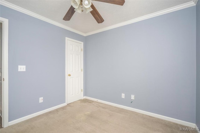 spare room featuring ornamental molding, light colored carpet, and ceiling fan