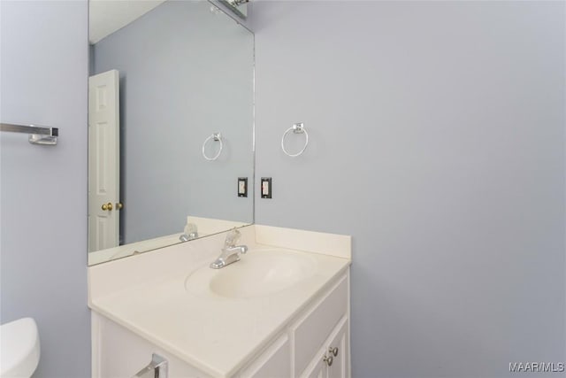 bathroom featuring toilet and vanity