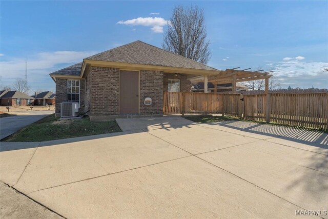 view of front of property with cooling unit and a pergola