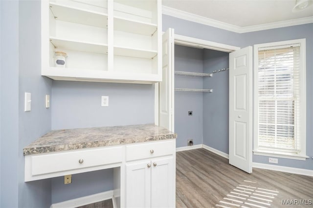 kitchen featuring white cabinets, light wood-type flooring, and crown molding