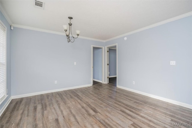 unfurnished room with crown molding, a chandelier, and hardwood / wood-style flooring