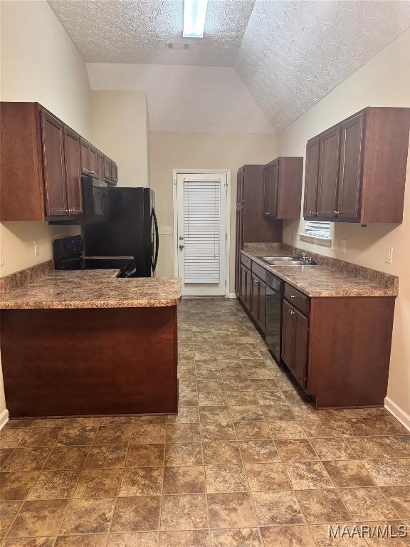 kitchen featuring lofted ceiling, black appliances, a textured ceiling, and dark brown cabinetry