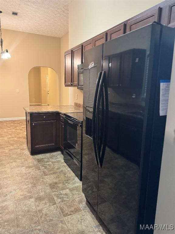 kitchen featuring pendant lighting, black appliances, kitchen peninsula, a textured ceiling, and a chandelier