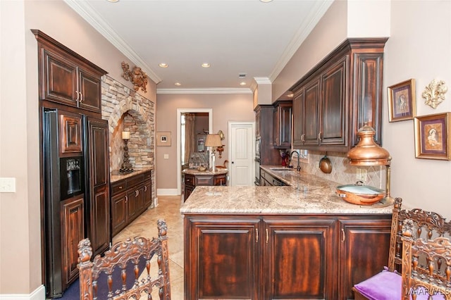 kitchen featuring crown molding, dark brown cabinets, kitchen peninsula, and sink