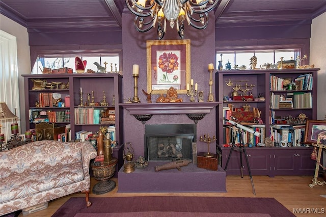 living area featuring ornamental molding, a chandelier, hardwood / wood-style flooring, and beamed ceiling