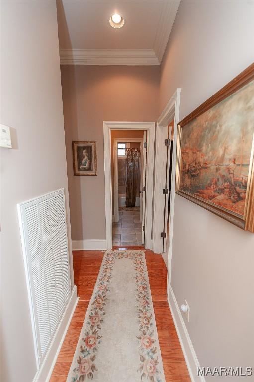 hallway featuring crown molding and hardwood / wood-style flooring