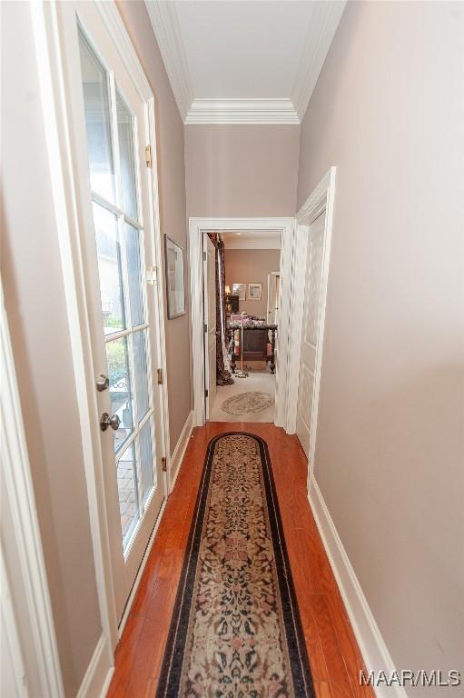 corridor with crown molding and hardwood / wood-style floors