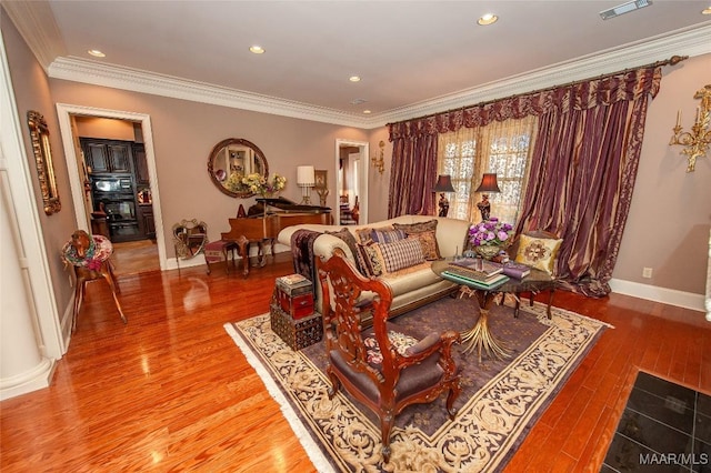 living room with crown molding and hardwood / wood-style floors