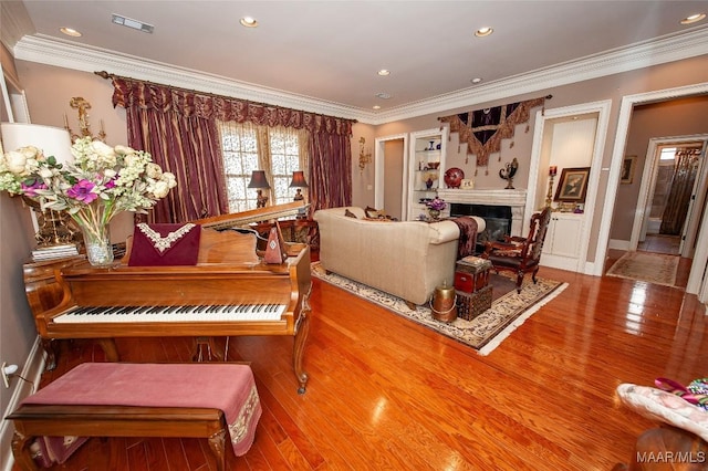 miscellaneous room with crown molding and hardwood / wood-style floors