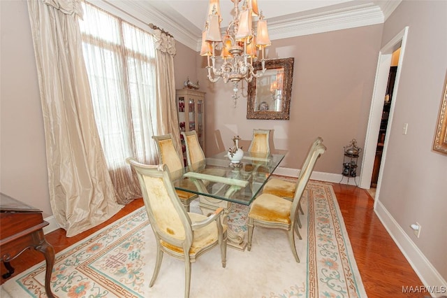 dining space with plenty of natural light, ornamental molding, and hardwood / wood-style flooring