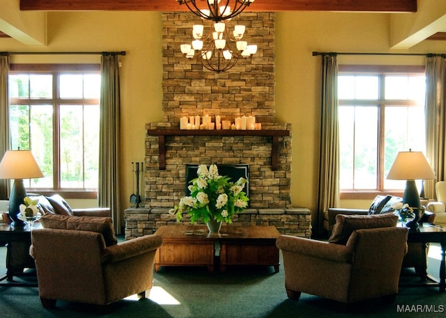 living area featuring a notable chandelier, a stone fireplace, and carpet floors