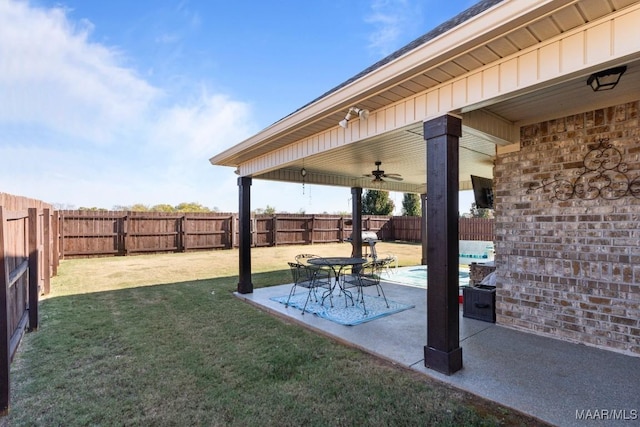 view of yard featuring ceiling fan and a patio area