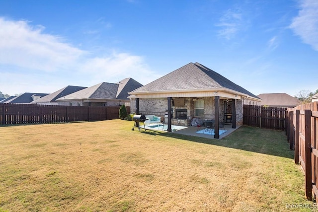 rear view of house featuring a yard and a patio