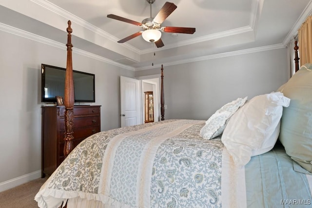 carpeted bedroom with ceiling fan, crown molding, and a tray ceiling