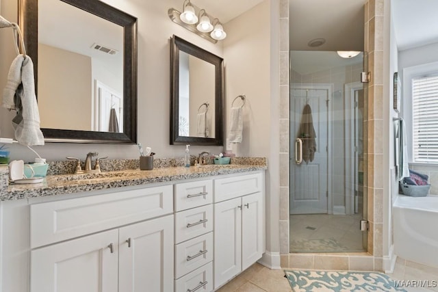 bathroom with tile patterned floors, separate shower and tub, and vanity