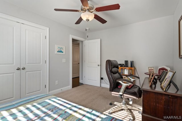 carpeted bedroom with ceiling fan and a closet