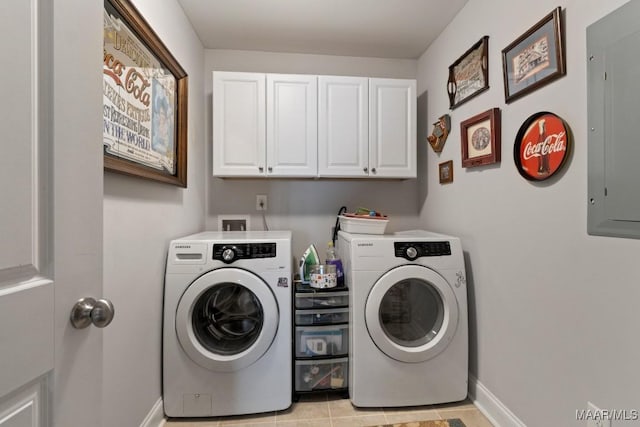 laundry area with light tile patterned floors, cabinets, electric panel, and washing machine and clothes dryer