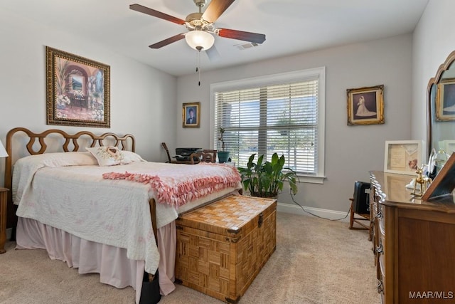 bedroom featuring ceiling fan and light carpet