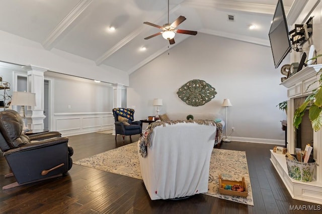 living room with decorative columns, dark wood-type flooring, ceiling fan, and vaulted ceiling with beams