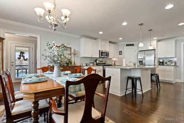 dining area featuring dark hardwood / wood-style floors, crown molding, and a chandelier