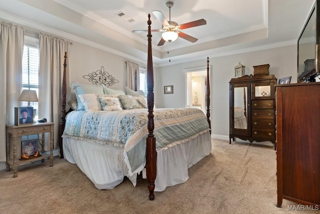 bedroom with light carpet, ceiling fan, ornamental molding, and a raised ceiling