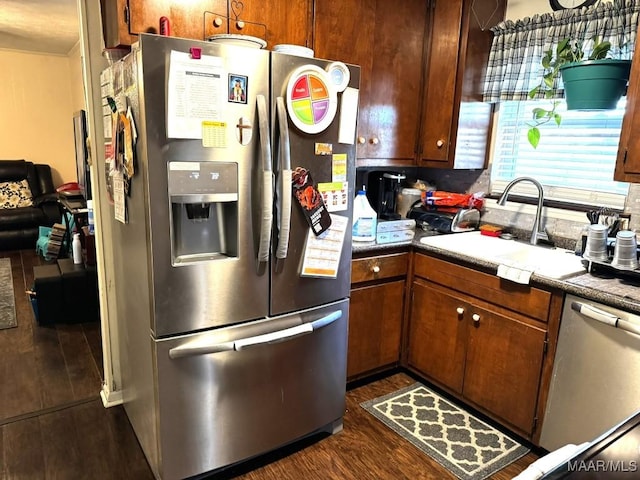 kitchen featuring appliances with stainless steel finishes, dark hardwood / wood-style floors, and sink