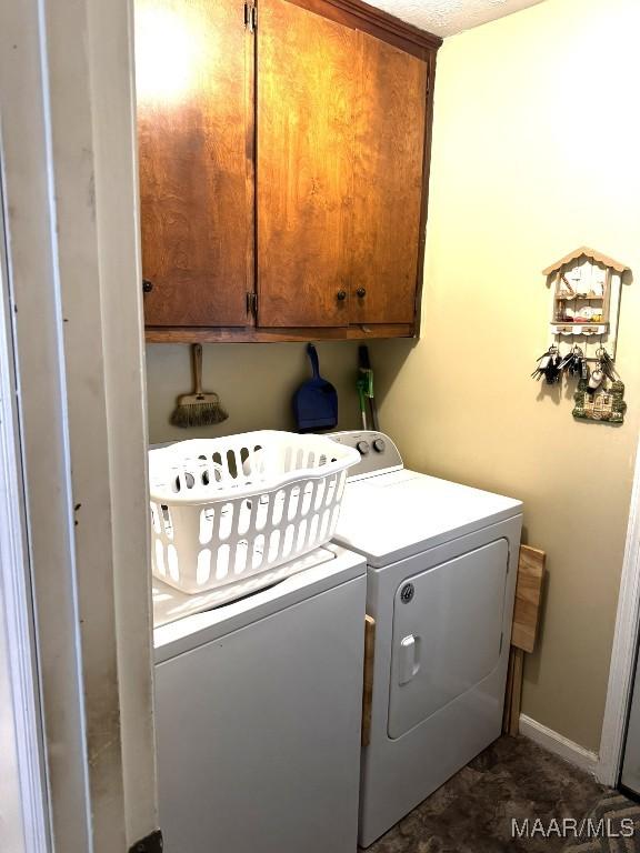 laundry room featuring cabinets and separate washer and dryer