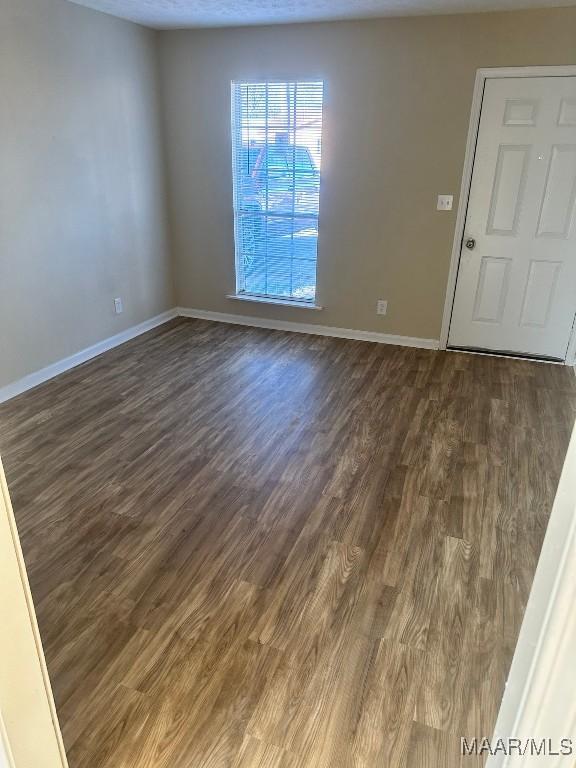 empty room featuring dark hardwood / wood-style floors