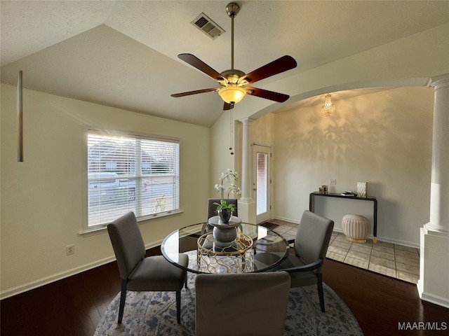 dining room featuring vaulted ceiling, ceiling fan, wood-type flooring, and decorative columns