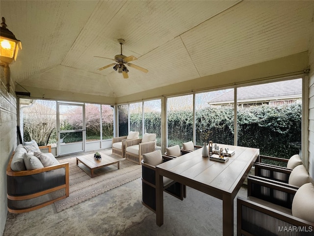 sunroom with ceiling fan and lofted ceiling